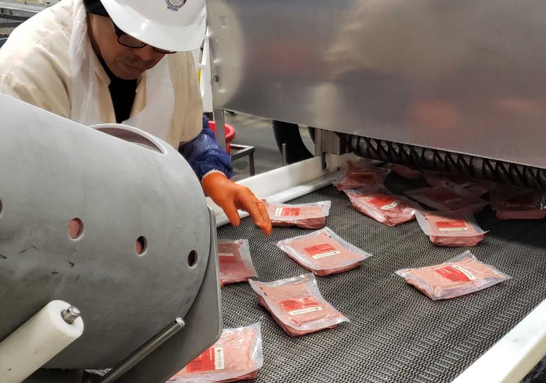 Raw dog food being packaged